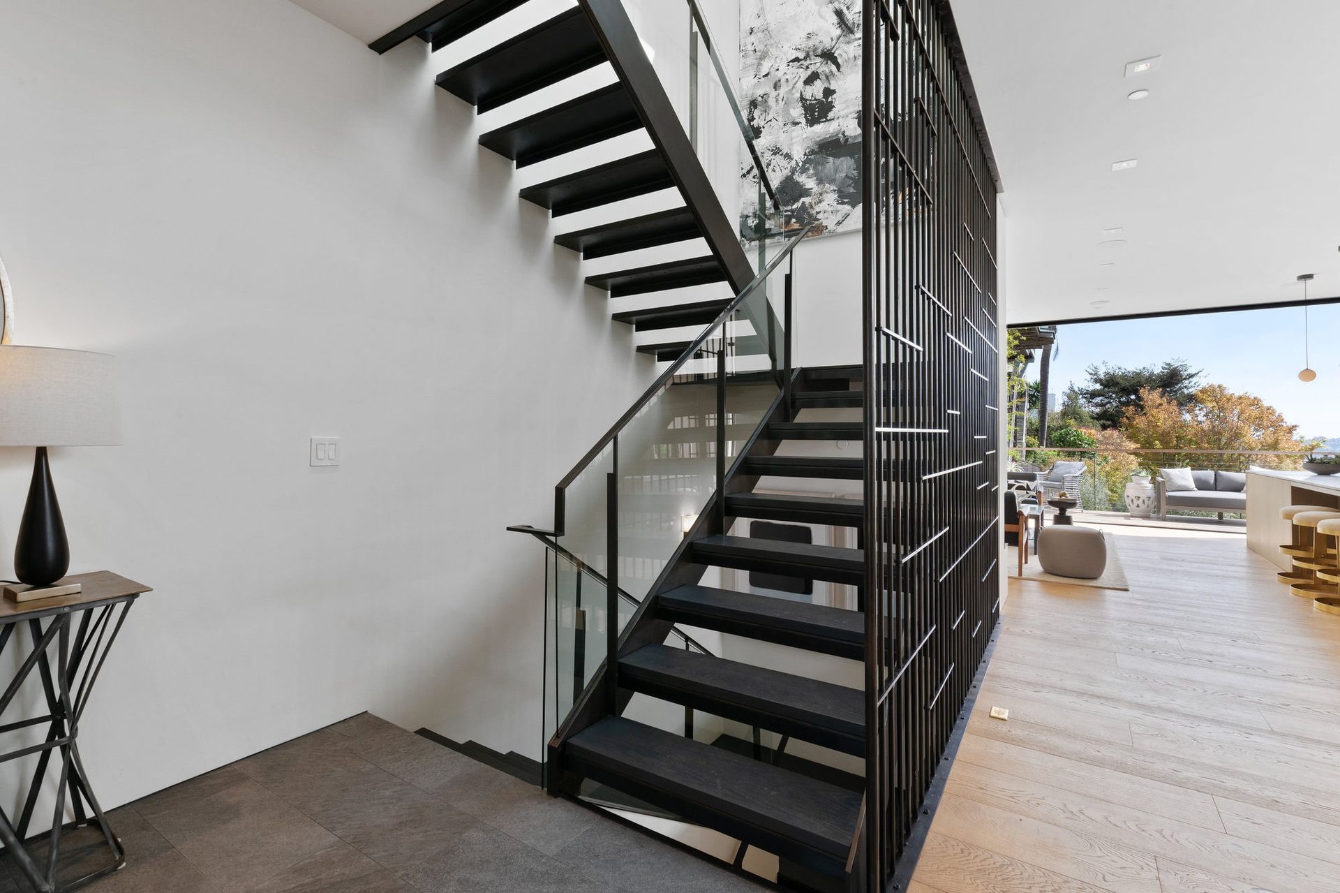 Floating steel-and-glass staircase with white oak floors