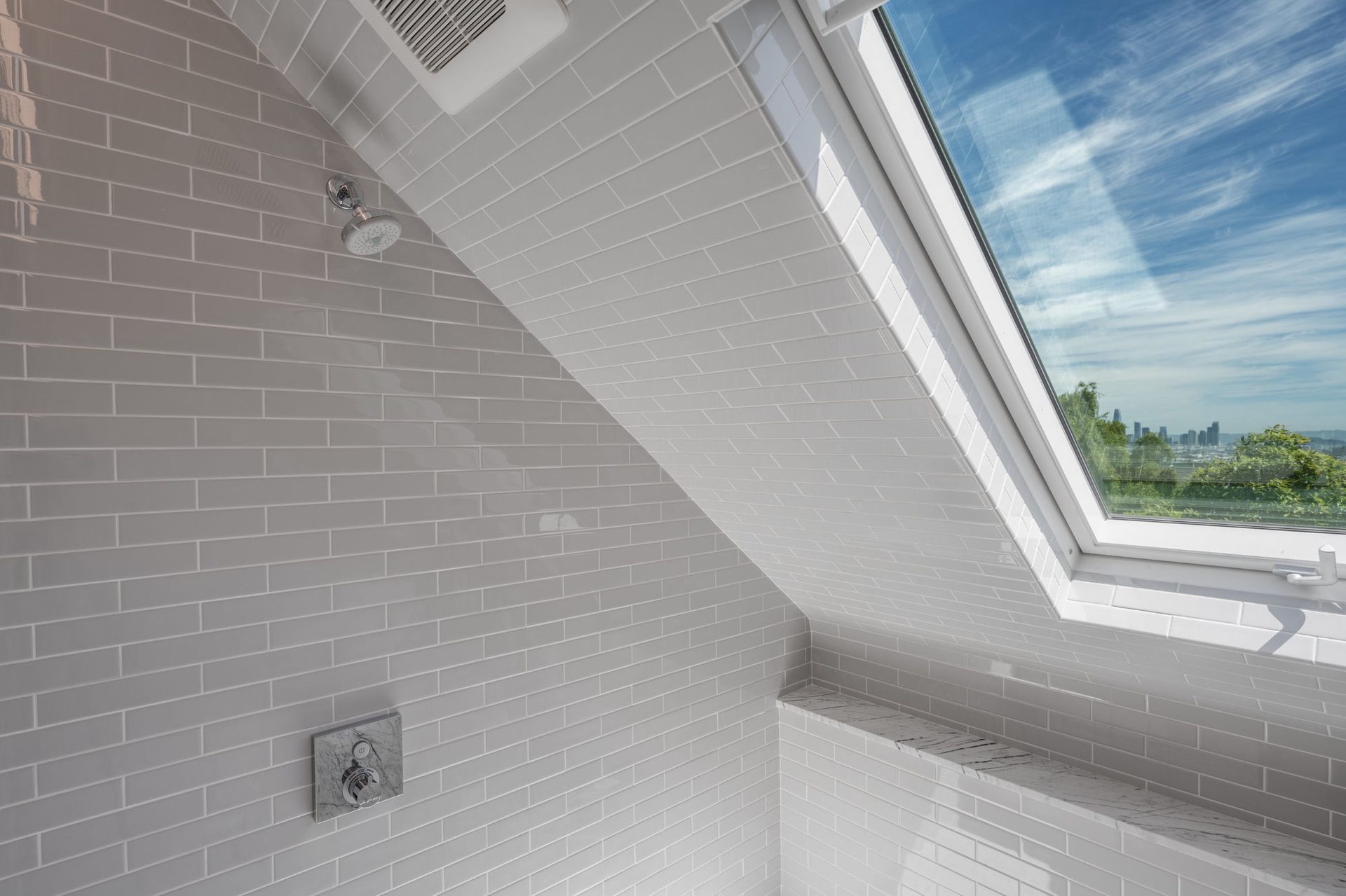 Skylit shower with city view