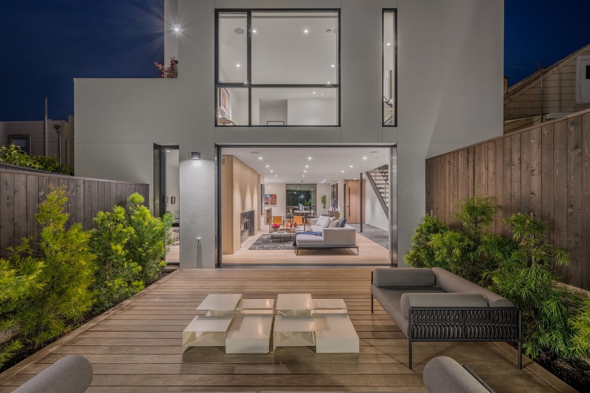 Indoor–outdoor living illuminated at dusk
